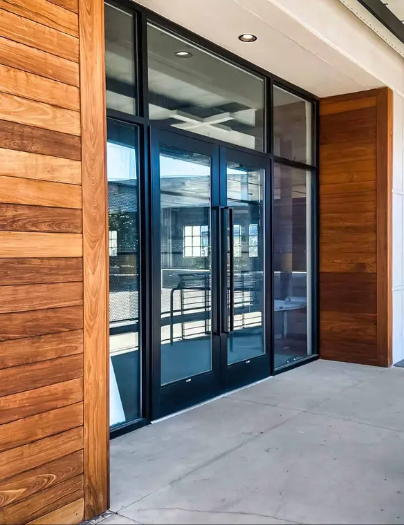 Modern office building with large glass windows, showcasing commercial door window solutions in Jacksonville, FL.