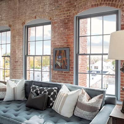 E-Series double-hung windows with colonial grilles in a historical building, showcasing architectural windows and doors.
