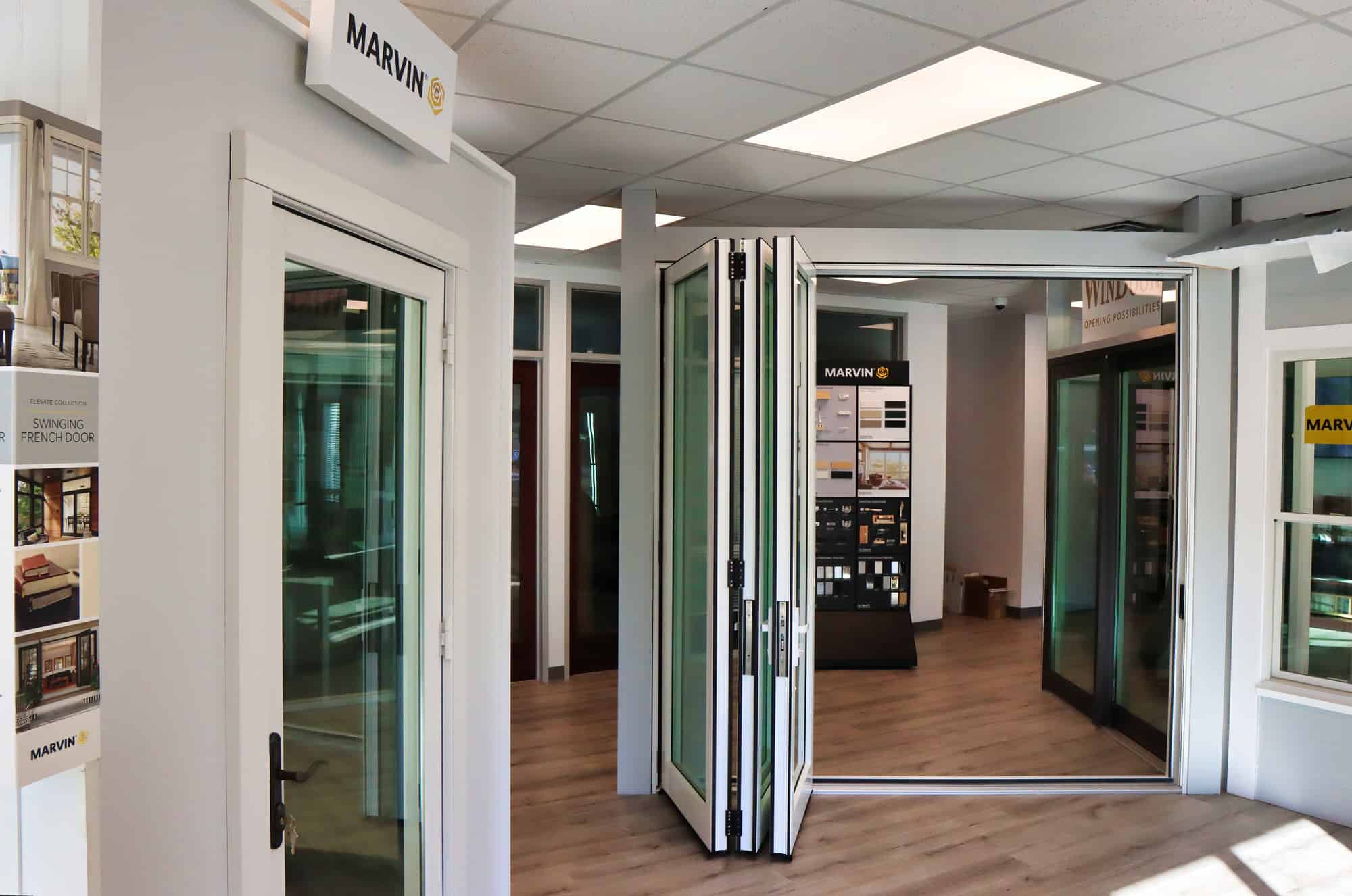 Exterior view of a modern building with large glass windows and a sleek design, representing Ace Door & Window Company.