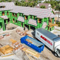 A modern garage door with sleek panels and a smooth finish, set in a residential exterior, showcasing contemporary design.