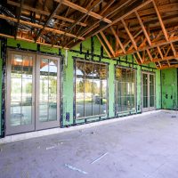 A modern garage door with sleek horizontal panels in a residential setting, showcasing contemporary design and functionality.